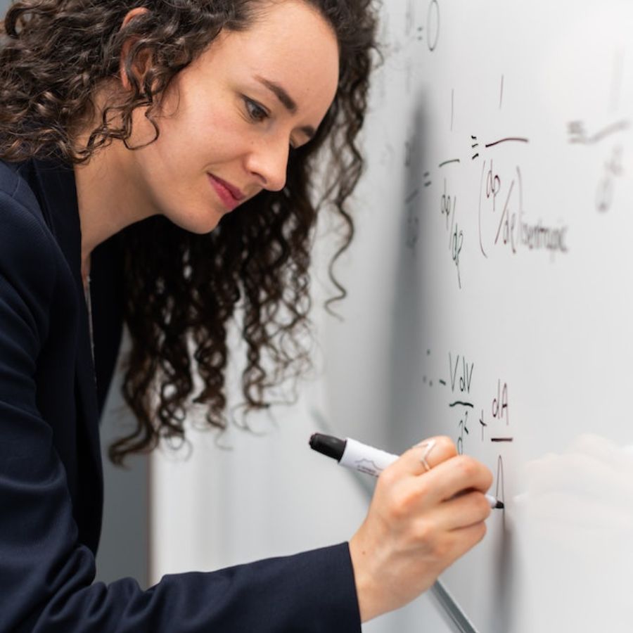 a woman calculating solar panel output